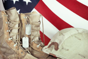 Close up of combat boots, helmet, and flag