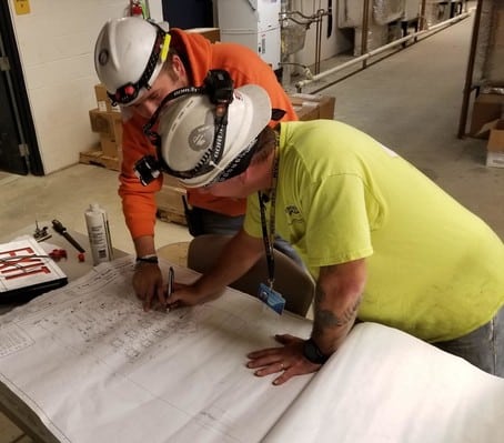 electricians drawing a plan