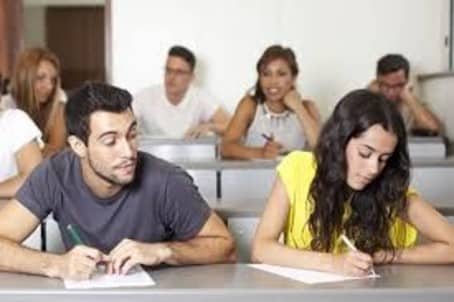 male student looking over the shoulder of female student