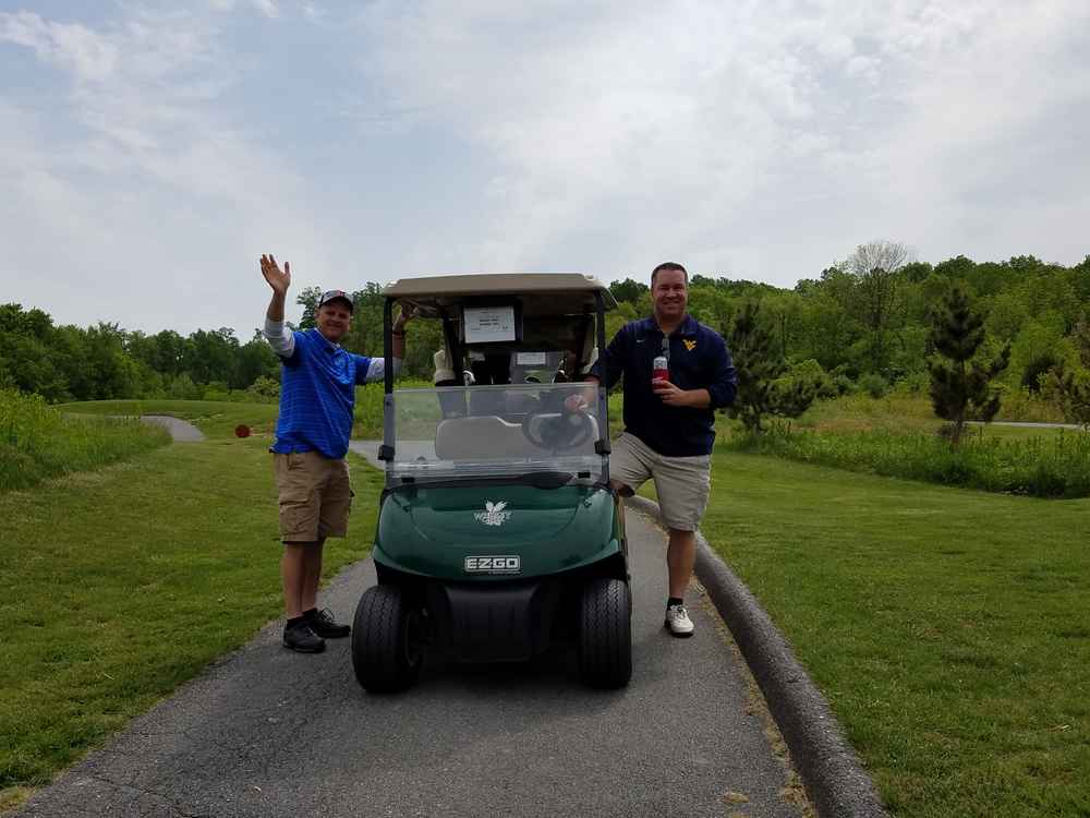 golfers with golf cart