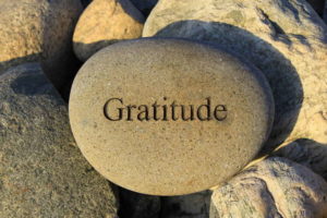 word gratitude carved into rock