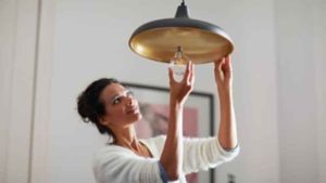 woman changing lightbulb